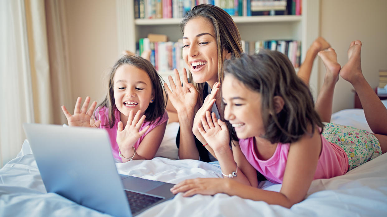 Mother and her daughters are making video call.