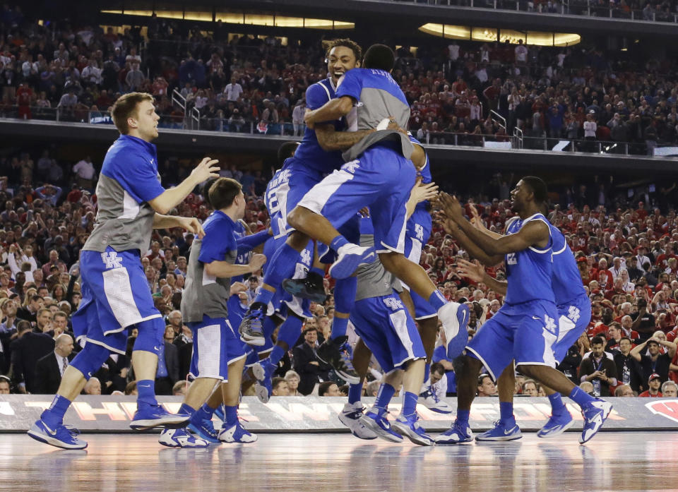 Kentucky celebrates after guard Aaron Harrison made a three-point basket in the final seconds against Wisconsin to win the game 74-73 during their NCAA Final Four tournament college basketball semifinal game Saturday, April 5, 2014, in Arlington, Texas. (AP Photo/David J. Phillip)