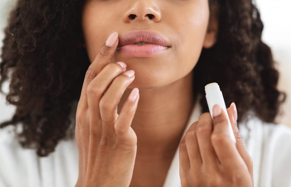 applying lip balm with finger