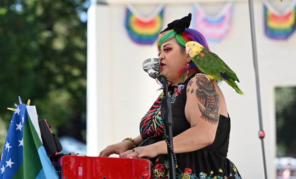 Melynda Rodriguez performs on the keyboard with her parrot Kauai during the MoPride festival at Graceada Park in Modesto, Calif., Saturday, Oct. 1, 2022. Andy Alfaro/aalfaro@modbee.com