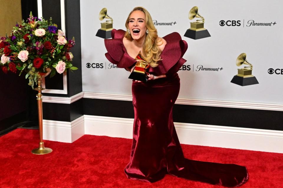 English singer-songwriter Adele poses with the award for Best Pop Solo Performance for “Easy on Me” (AFP via Getty Images)