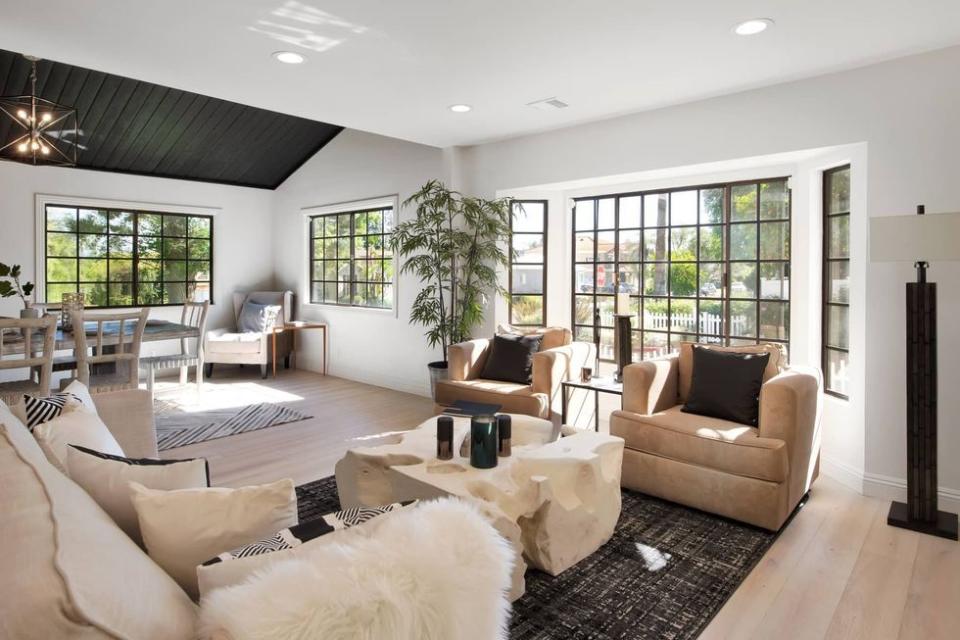 living room and dining room with vaulted ceiling