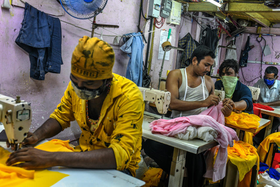 "My family was worried about the disease and didn’t want me to return to the city, but I had to come back to work," said Ishrar Ali, who stitches women's tops in a garment workshop in Dharavi.<span class="copyright">Atul Loke for TIME</span>