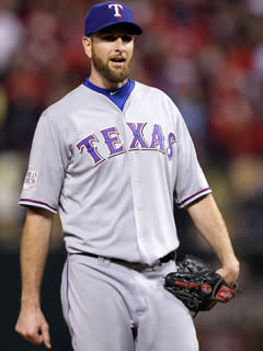 Texas reliever Scott Feldman reacts after walking Yadier Molina with the bases loaded in the fifth inning of Game 7