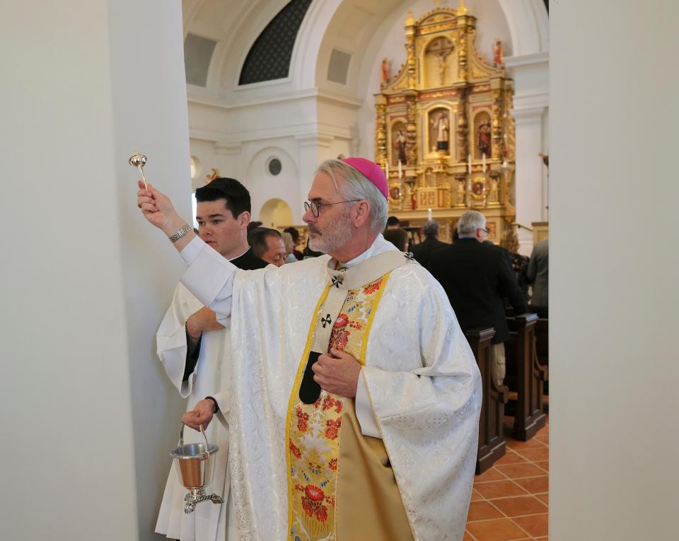 Archbishop Paul S. Coakley sprinkles Holy Water on the walls and the congregation at the Mass for the Dedication of a Church and Altar at the Blessed Stanley Rother Shrine Friday, February 17, 2023