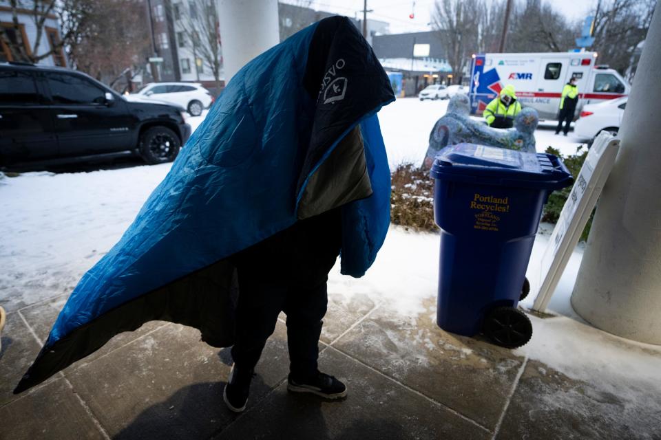 A person walks to Friendly House which opened as an emergency warming shelter on Saturday, Jan. 13, 2024, in Portland, Ore. (AP Photo/Jenny Kane) ORG XMIT: ORJK123