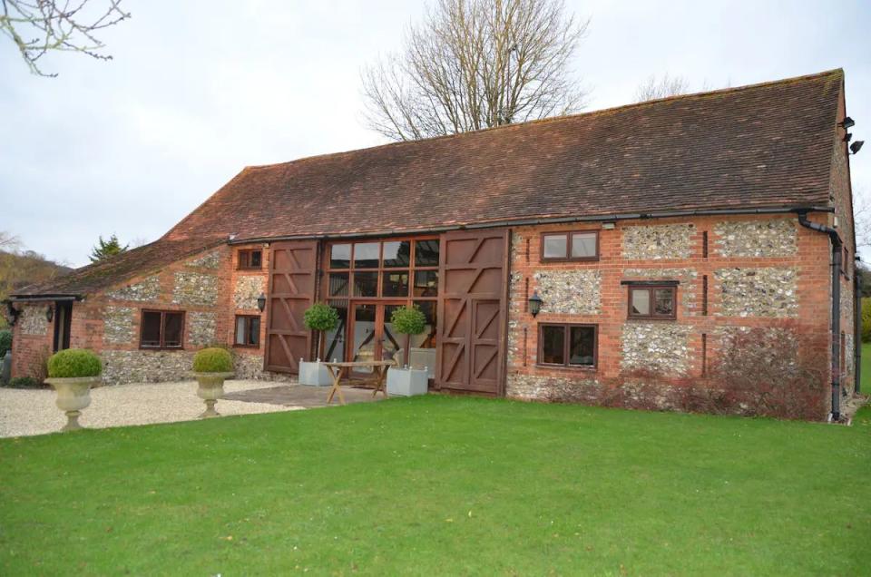 a brick house with a grass yard