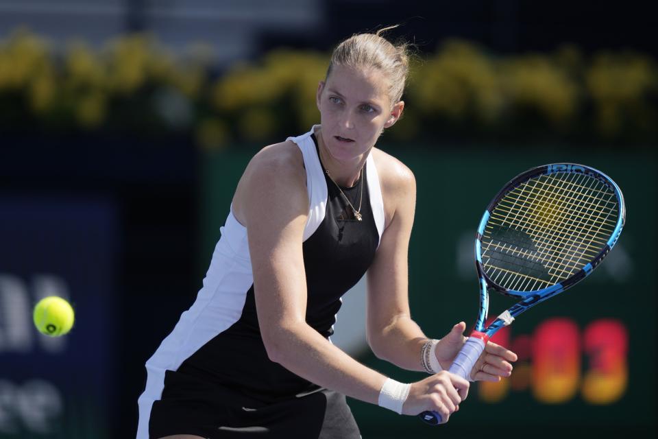 Karolina Pliskova of Czech Republic returns the ball to Zhang Shuai of China during a match of the Dubai Duty Free Tennis Championships in Dubai, United Arab Emirates, Monday, Feb. 19, 2024. (AP Photo/Kamran Jebreili)