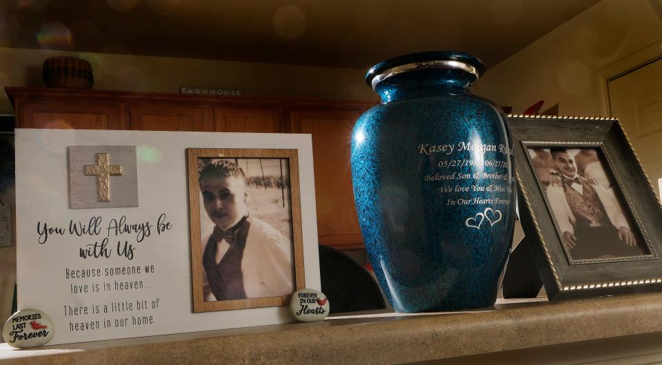 Kasey Russell's urn and photos rest on a shelf Wednesday in the home of his mother, Annetta Russell. Kasey Russell went missing after a fight with his girlfriend, but law enforcement didn't look for him. It wasn't until years later that his body was discovered. Now his family and their supporters hope Oklahoma will set up an alert system to help missing adults like Kasey. They see it as an important way to respond to the crisis of missing and murdered Indigenous people.