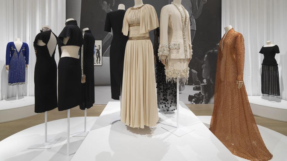 a group of dresses on display