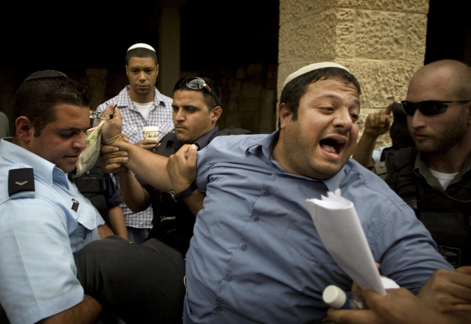 FILE - In this May 27, 2010, file photo, Israeli right-wing activist Itamar Ben Gvir is detained by police after shouting slogans at White House Chief of Staff Rahm Emanuel, during his visit to Jerusalem’s Old City. An alliance of far-right groups including openly racist and homophobic candidates appears poised to enter Israel’s parliament, possibly as an indispensable member of Prime Minister Benjamin Netanyahu’s right-wing coalition, according to exit polls Tuesday, March 23, 2021. (AP Photo/Sebastian Scheiner, File)