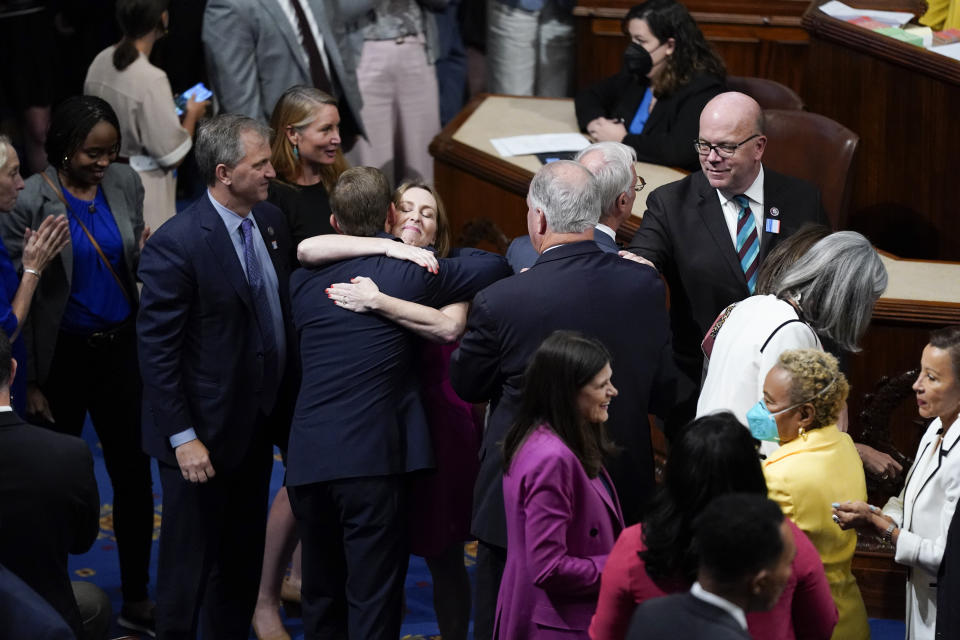 Members of the House of Representatives gather in the chamber to celebrate after the vote to approve the Inflation Reduction Act at the Capitol in Washington, Friday, Aug. 12, 2022. A divided Congress gave final approval Friday to Democrats' flagship climate and health care bill. The House used a party-line 220-207 vote to pass the legislation. (AP Photo/Patrick Semansky)