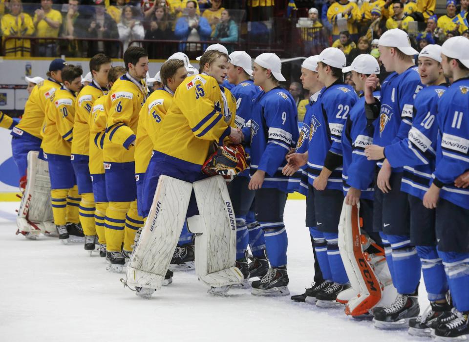 Sweden's goalie Oscar Dansk leads his teammates in shaking hands with Finland players after they lost in overtime of their IIHF World Junior Championship gold medal ice hockey game in Malmo, Sweden, January 5, 2014. REUTERS/Alexander Demianchuk (SWEDEN - Tags: SPORT ICE HOCKEY)