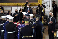 President Joe Biden stands as a joint services honor guard carries the flag-draped casket of U.S. Capitol Police officer William "Billy" Evans, to where he will lie in honor at the Capitol in Washington, Tuesday, April 13, 2021. (Amr Alfiky/The New York Times via AP, Pool)