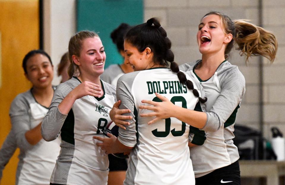 Vivian Castano (33) celebrates with her Dennis-Yarmouth teammates Kate McGrath (left) and Ava Pecorella (right) after passing the 1000 assist point during their Sept. 26 match with Sandwich in South Yarmouth.