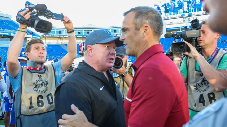 Kentucky coach Mark Stoops congratulates South Carolina coach Shane Beamer after the Gamecocks defeated the Wildcats 31-6 Saturday at Kroger Field.