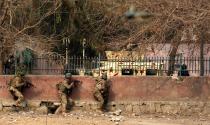 <p>Afghan security officials take position in a nearby building after an attack on the headquarters of the non-governmental organization Save the Children in Jalalabad, Afghanistan, Jan. 24, 2018. (Photo: Ghulamullah Habibi/EPA-EFE/REX/Shutterstock) </p>