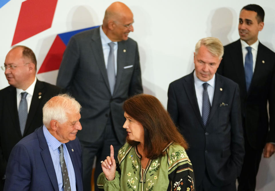 Sweden's Foreign Minister Ann Linde, center, speaks with European Union foreign policy chief Josep Borrell, second left, during a group photo of EU foreign ministers at the Prague Congress Center in Prague, Czech Republic, Wednesday, Aug. 31, 2022. Others from left, Romania's Foreign Minister Bogdan Aurescu, Greek Foreign Minister Nikos Dendias, Finland's Foreign Minister Pekka Haavisto and Italy's Foreign Minister Luigi Di Maio. (AP Photo/Petr David Josek)