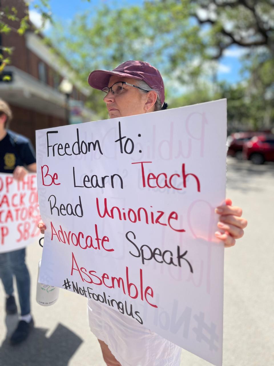 Teachers protest outside the office of Florida state Sen. Ben Albritton in April. They were protesting the expansion of private school vouchers, which was signed into law four days earlier, as well as a bill that takes aim at certain public-sector unions, including teachers' unions.