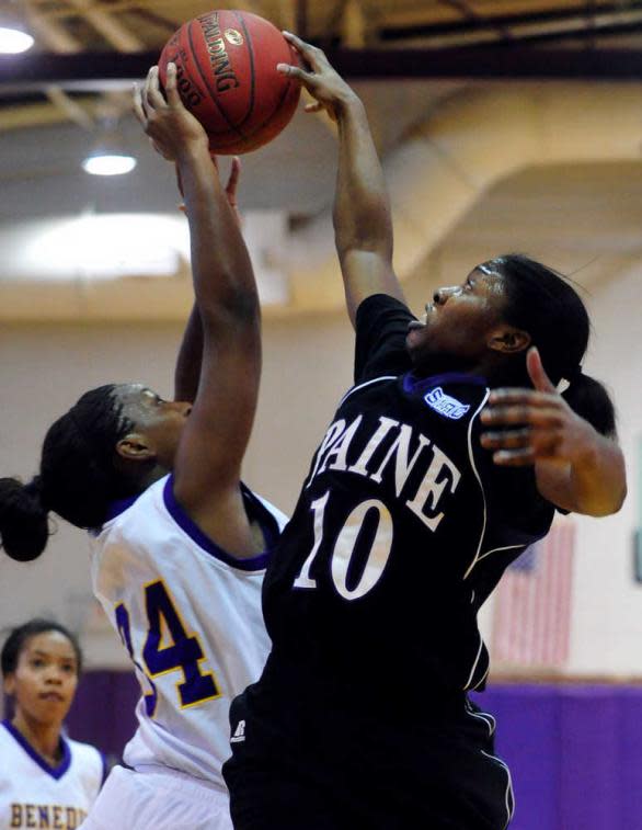 Ariel Brown (No. 10) blocks a shot playing for Paine College, where she was also a member of the volleyball team.