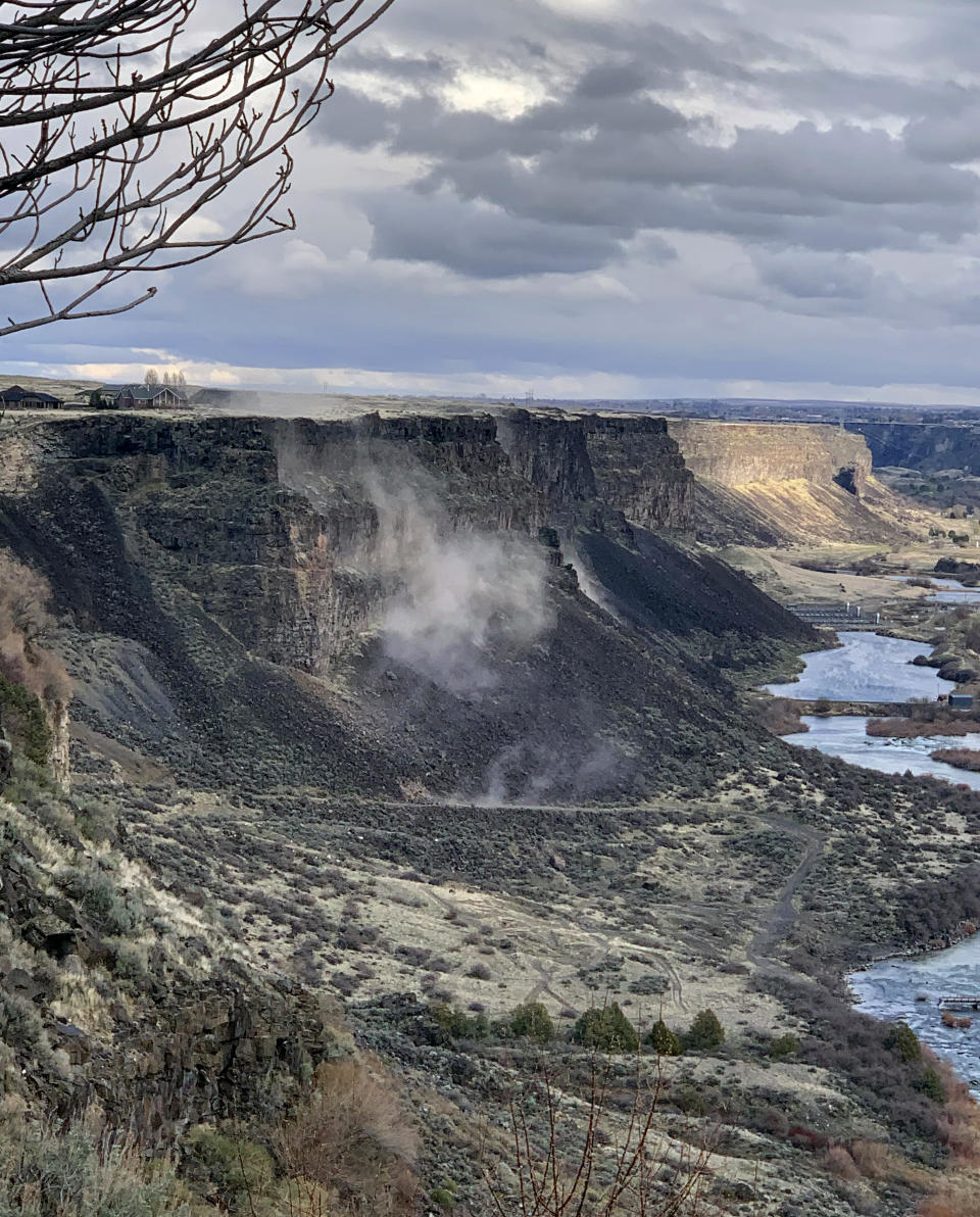 In a photo provided by Israel Bravo, rocks fall from the north side of the Snake River Canyon during an earthquake, Tuesday, March 31, 2020, near Twin Falls, Idaho. A large earthquake struck north of Boise on Tuesday evening, with people across a large area reporting shaking. (Israel Bravo via AP)