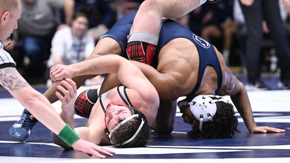 Penn State’s Carter Starocci (right) attempts to pin Edinboro’s Joey Arnold at 174 pounds during Sunday’s final home wrestling meet at Rec. Hall in University Park. Starocci went on to win by tech fall before suffering an injury. Penn State defeated Edinboro, 55-0. (Steve Manuel for the CDT).