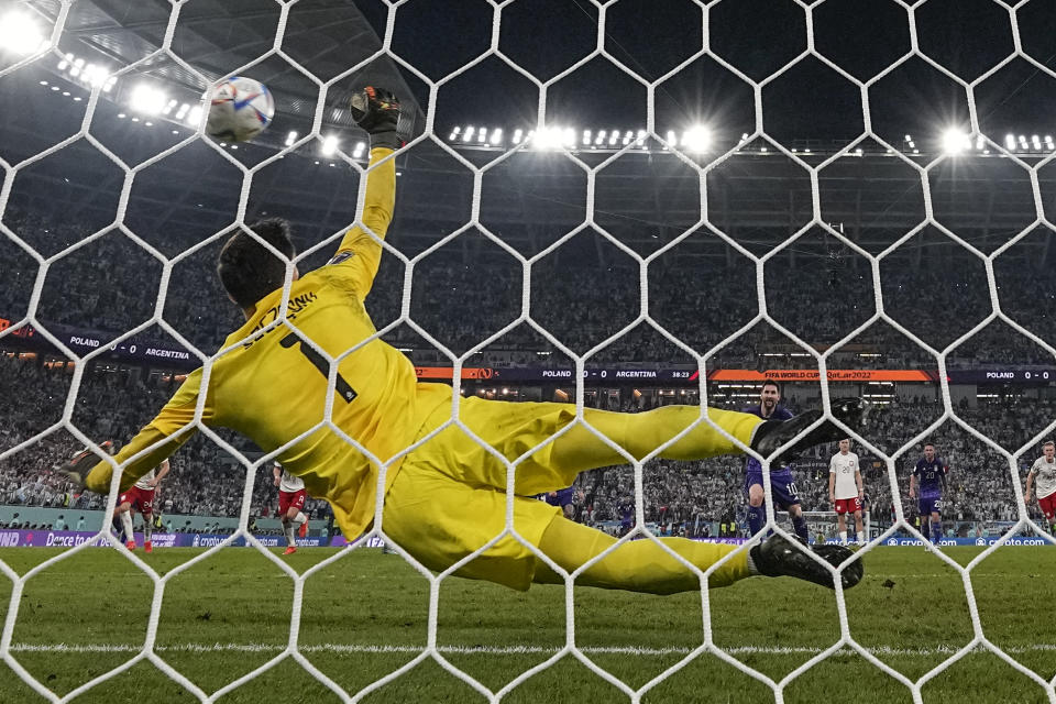 Poland's goalkeeper Wojciech Szczesny saves a penalty kick by Argentina's Lionel Messi during the World Cup group C soccer match between Poland and Argentina at the Stadium 974 in Doha, Qatar, Wednesday, Nov. 30, 2022. (AP Photo/Ariel Schalit)