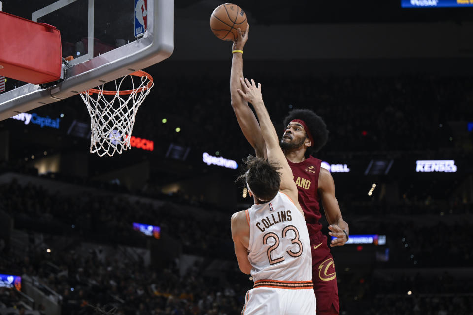 Cleveland Cavaliers' Jarrett Allen, top, attempts to dunk over San Antonio Spurs' Zach Collins (23) during the first half of an NBA basketball game, Saturday, Feb. 3, 2024, in San Antonio. (AP Photo/Darren Abate)