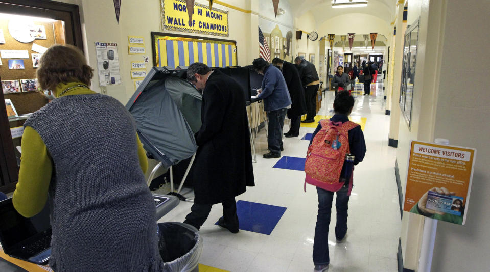 Voters cast their ballots at North Hi Mount Elementary School as children make their way to class Tuesday March 4, 2014 Fort Worth, Texas. Texas is holding the nation's first primary election Tuesday with a political free-for-all in Republican races that could push the state further right, though Democrats are calling it the next big battleground on the electoral map. (AP Photo/The Fort Worth Star-Telegram, Ron Jenkins) MAGS OUT; (FORT WORTH WEEKLY, 360 WEST); INTERNET OUT