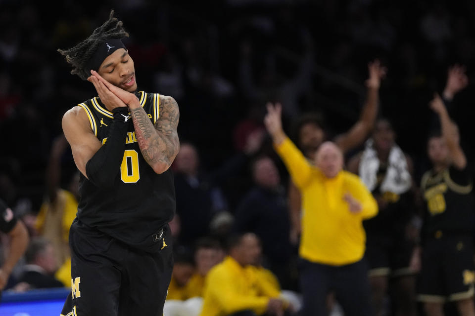 Michigan's Dug McDaniel (0) gestures after making a three-point shot during the second half of an NCAA college basketball game against St. John's Monday, Nov. 13, 2023, in New York. (AP Photo/Frank Franklin II)