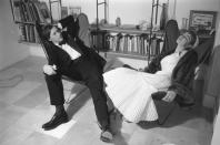 June 1955: Designer and restauranteur Sir Terence Conran, founder of Habitat, with his wife journalist and author Shirley relaxing at home in hammock chairs. Original Publication: Picture Post - 8083 - Twenty Shillings Or Twenty Pounds - unpub. (Photo by Thurston Hopkins/Picture Post/Hulton Archive/Getty Images)