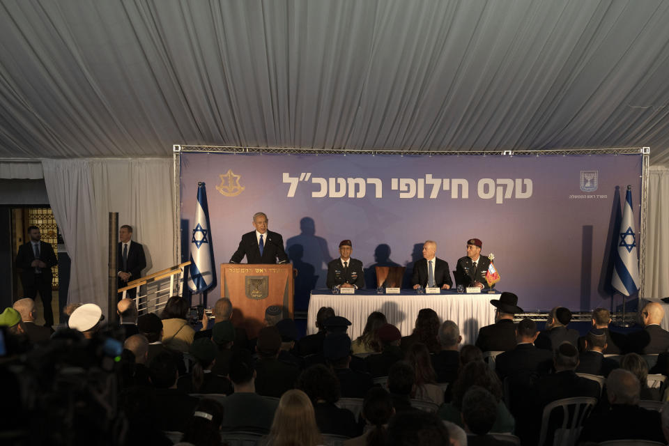 Israel's Prime Minister Benjamin Netanyahu, left, speaks at a transition ceremony for the outgoing Israel Defense Forces Chief of Staff Aviv Kochavi, second left, with Defense Minister Yoav Gallant, second right, and promoting incoming Chief-of-Staff Herzi Halevi, right, to the rank of Lieutenant-General, in Jerusalem, Monday, Jan. 16, 2023. (AP Photo/ Maya Alleruzzo, Pool)