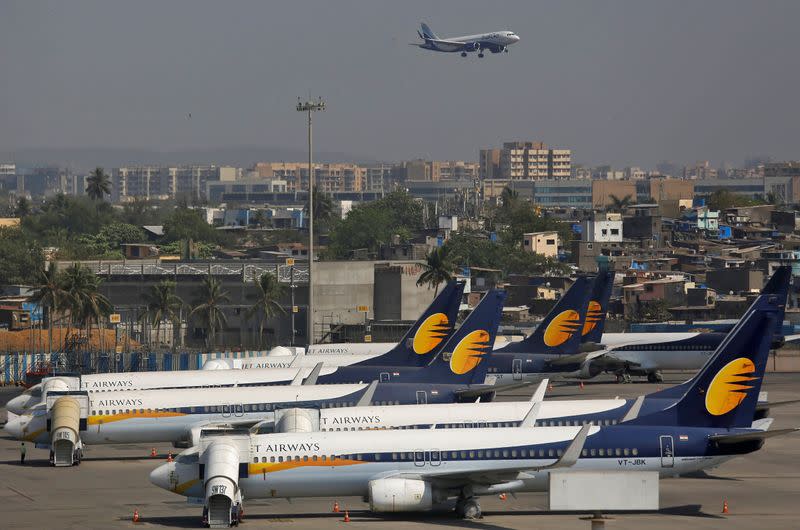 FILE PHOTO: Jet Airways aircrafts are seen parked as an IndiGo Airlines aircraft prepares to land at the Chhatrapati Shivaji Maharaj International Airport in Mumbai