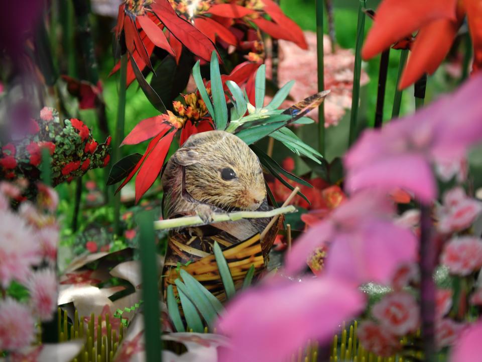 Sandy Payson included a squirrel in her paper flower garden.  Payson has created a garden of sculptural paper flowers in her Sarasota home. 