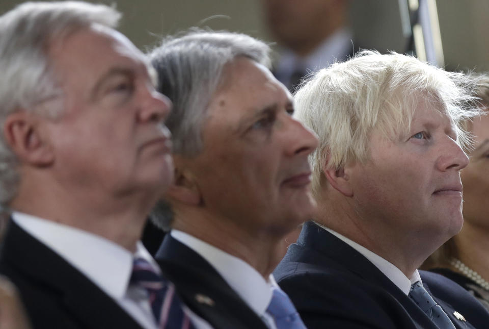 From left, Britain's chief Brexit negotiator David Davis, Chancellor of the Exchequer Philip Hammond and Foreign Secretary Boris Johnson attend a speech by Prime Minister Theresa May, in Florence, Italy, Friday Sept. 22, 2017. May will try Friday to revive foundering Brexit talks — and unify her fractious government — by proposing a two-year transition after Britain's departure from the European Union in 2019 during which the U.K. would continue to pay into the bloc's coffers. (AP Photo/Alessandra Tarantino, Pool)