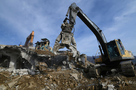 Construction equipment destroy a South Korean guard post in the Demilitarized Zone dividing the two Koreas in Cheorwon on November 15, 2018. Jung Yeon-je/Pool via Reuters