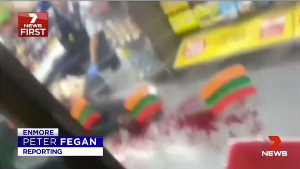 One man was filmed lying in a pool of blood after he had just been struck in the face with an axe. Source: 7 News.