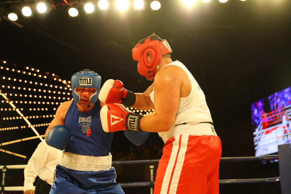 <p>Jerry Packtor (red) connects against opponent Mark Sinatra (blue) in Super Heavyweight action during the NYPD Boxing Championships at the Hulu Theater at Madison Square Garden on March 15, 2018. (Gordon Donovan/Yahoo News) </p>