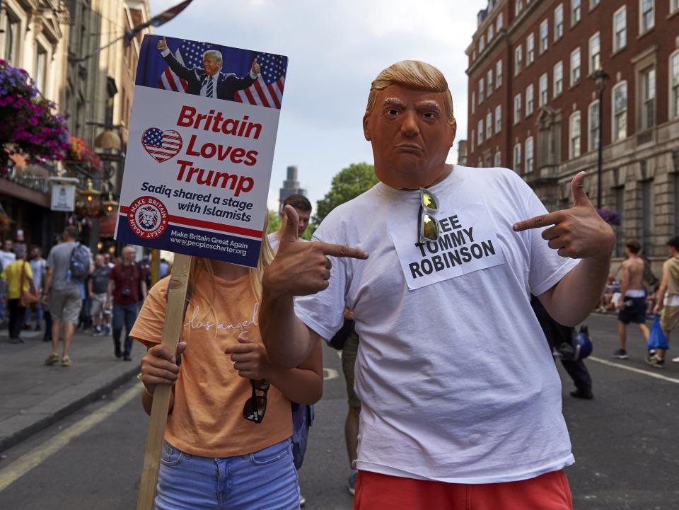 Trump supporters pose for the camera as they mix with protesters at a London rally by supporters of far-right spokesman Tommy Robinson in Trafalgar Square, 14 July 2018AFP/Getty