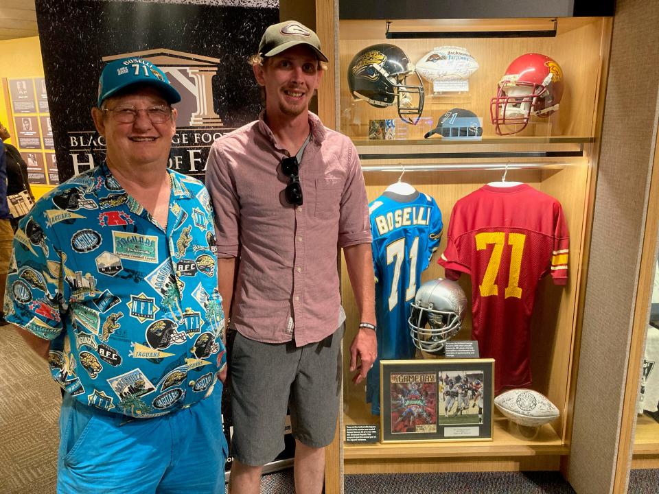 Rick Adams, left, a Jacksonville resident since 1980, and his son Joseph stand next to Tony Boselli’s locker at the Pro Football Hall of Fame in Canton, Ohio. They attended the first Jaguars regular-season game together against the Houston Oilers in 1995.