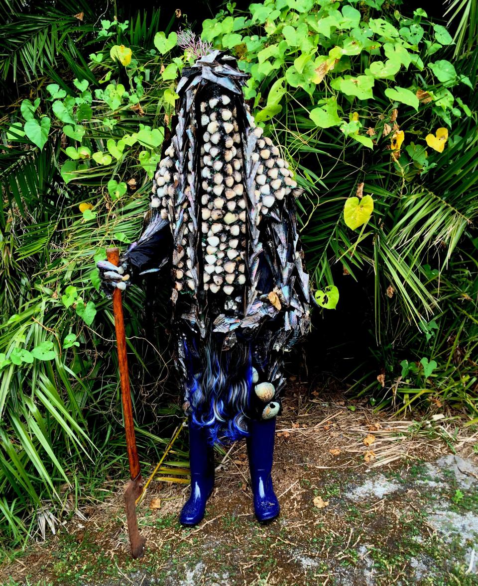 A still from Cauleen Smith's 2017 video "Egungun: Ancestor Can't Find Me," seen in The Ringling exhibition “Embodied,” reveals a shrouded figure moving through a subtropical ecosystem. It was filmed on Captiva Island.
