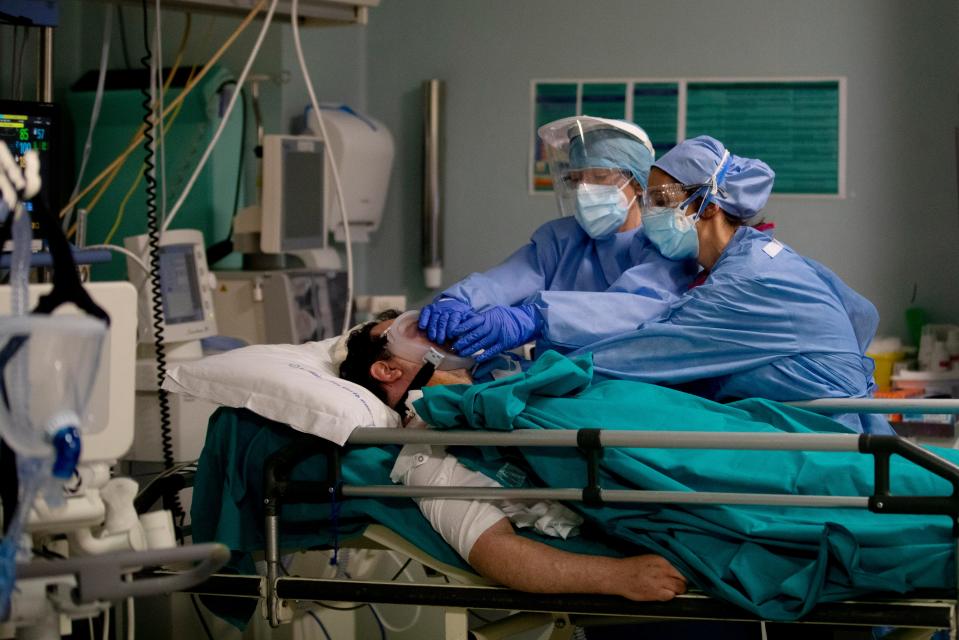 FILE - In this April 16, 2020 file photo, medical staff tend to a patient in the emergency COVID-19 ward at the San Carlo Hospital in Milan, Italy. As Italy prepares to emerge from the West’s first and most extensive coronavirus lockdown, it is increasingly clear that something went terribly wrong in Lombardy, the hardest-hit region in Europe’s hardest-hit country. By contrast, Lombardy’s front-line doctors and nurses are being hailed as heroes for risking their lives to treat the sick under extraordinary levels of stress, exhaustion, isolation and fear. (AP Photo/Antonio Calanni, file)