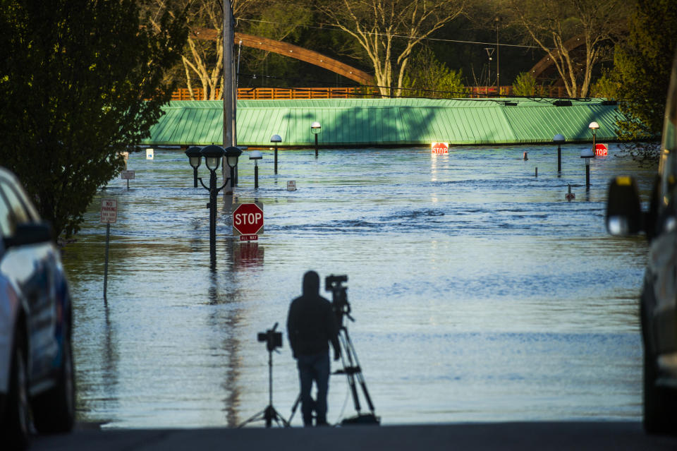 People head to downtown Midland, Mich., to check out the flood level early Wednesday morning, May 20, 2020. (Katy Kildee/Midland Daily News via AP)