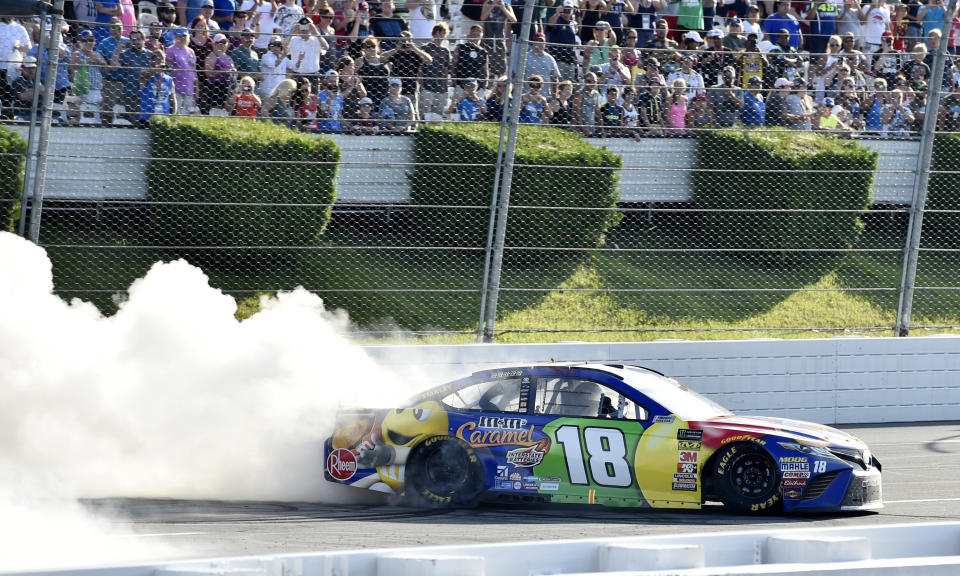 Kyle Busch celebrates with a burnout after winning a NASCAR Cup Series auto race, Sunday, July 29, 2018, in Long Pond, Pa. (AP Photo/Derik Hamilton)