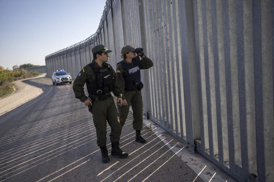 Police border guards patrol along a border wall near the town of Feres, along the Evros River which forms the the frontier between Greece and Turkey on Sunday, Oct. 30, 2022. Greece is planning a major extension of a steel wall along its border with Turkey in 2023, a move that is being applauded by residents in the border area as well as voters more broadly. (AP Photo/Petros Giannakouris)