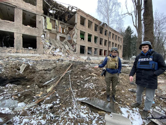 Journalists visit the site of a rocket attack launched by Russian invaders