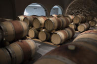 Wine barrels sit in a wine cellar in the southern France region of Provence, Friday Oct. 11, 2019. European producers of premium specialty agricultural products like French wine, Italian Parmesan and Spanish olives are facing Friday’s U.S. tariff hike with a mix of trepidation and indignation at being dragged into a trade war over the fiercely competitive aerospace industry. (AP Photo/Daniel Cole)