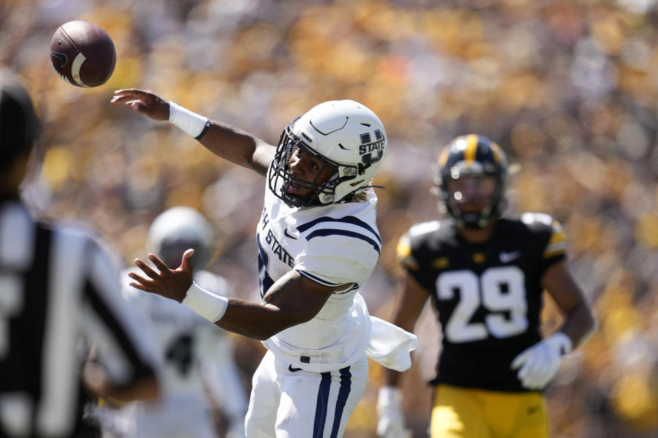 Utah State wide receiver Terrell Vaughn (0) tries to make a reception in front of Iowa defensive back Sebastian Castro (29) during the first half of an NCAA college football game, Saturday, Sept. 2, 2023, in Iowa City, Iowa. The pass was incomplete. (AP Photo/Charlie Neibergall)