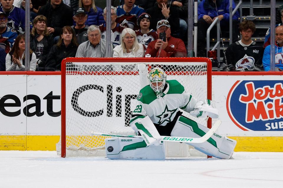 Dallas Stars goaltender Jake Oettinger (29) deflects a shot in the third period against the Colorado Avalanche in game four of the second round of the 2024 Stanley Cup Playoffs at Ball Arena.