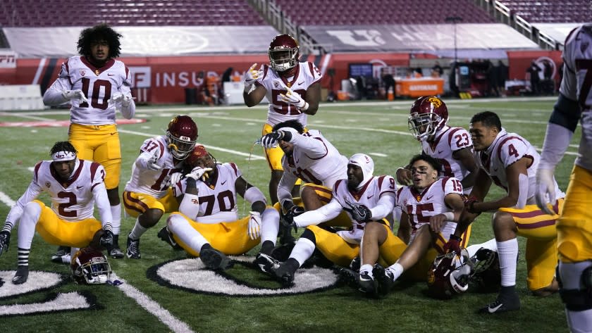 Southern California players pose for a photograph after their NCAA college football game against Utah